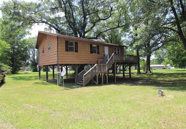 803 Reeder Rd, Leola, AR 72084 - rear view of house featuring stairs, a lawn, and a wooden deck