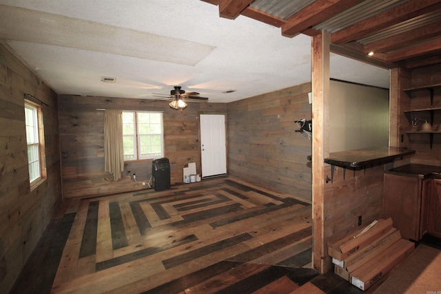 803 Reeder Rd, Leola, AR 72084 - interior space featuring wood walls, a ceiling fan, and wood finished floors