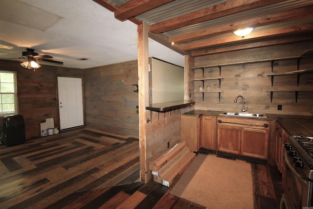 803 Reeder Rd, Leola, AR 72084 - bar area with a sink, wood walls, dark wood-type flooring, ceiling fan, and gas stove
