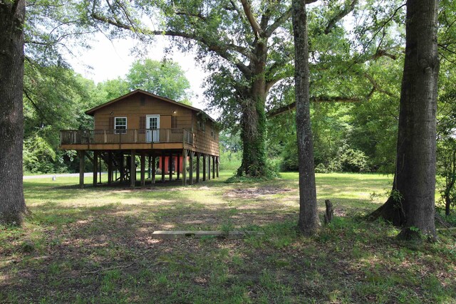 803 Reeder Rd, Leola, AR 72084 - rear view of house with a wooden deck and a lawn