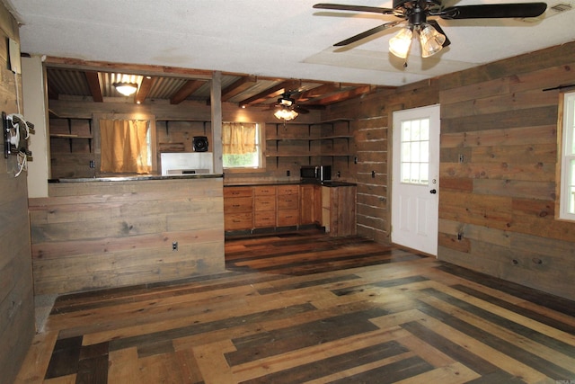 803 Reeder Rd, Leola, AR 72084 - kitchen with open shelves, wood walls, ceiling fan, healthy amount of natural light, and dark wood finished floors