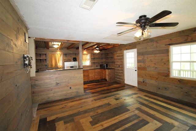 803 Reeder Rd, Leola, AR 72084 - kitchen featuring wooden walls, ceiling fan, and dark wood-type flooring