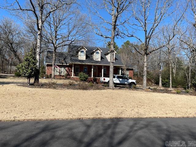 3165 Majestic Cir, Conway, AR 72034 - cape cod house featuring a porch