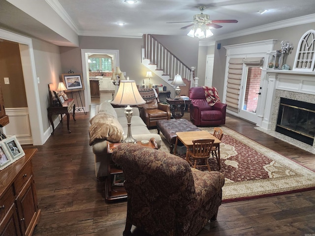 3165 Majestic Cir, Conway, AR 72034 - living room featuring a high end fireplace, dark wood-style flooring, a ceiling fan, ornamental molding, and stairway