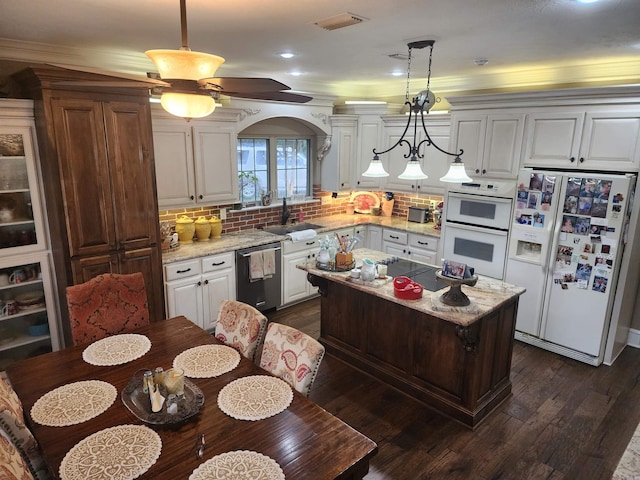 3165 Majestic Cir, Conway, AR 72034 - kitchen featuring white appliances, dark wood finished floors, tasteful backsplash, white cabinetry, and a center island