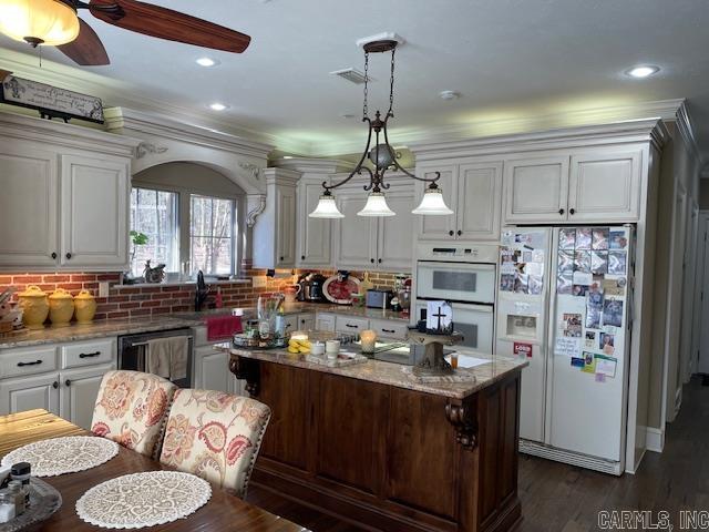 3165 Majestic Cir, Conway, AR 72034 - kitchen featuring white appliances, white cabinets, crown molding, light stone counters, and tasteful backsplash