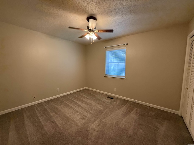 913 Schriner Ct, North Little Rock, AR 72116 - unfurnished bedroom with dark carpet, a closet, a textured ceiling, and ceiling fan