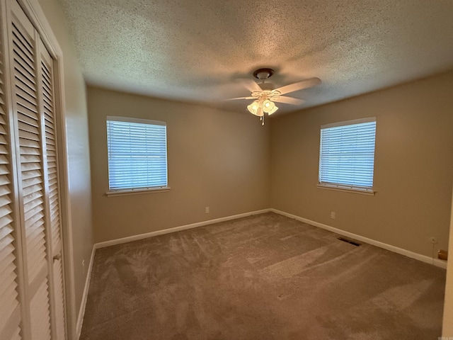 913 Schriner Ct, North Little Rock, AR 72116 - unfurnished bedroom with multiple windows, a textured ceiling, carpet flooring, a closet, and a ceiling fan