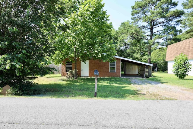 404 Reiff Ave, Searcy, AR 72143 - view of front of house featuring driveway, an attached carport, a front yard, and brick siding