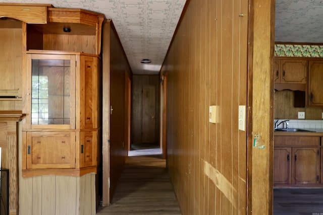 404 Reiff Ave, Searcy, AR 72143 - hallway with wallpapered walls, wood finished floors, wooden walls, and a sink
