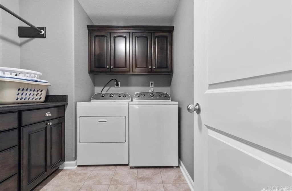 1210 Skyline Dr, Sheridan, AR 72150 - laundry area with washer and dryer, cabinet space, baseboards, and light tile patterned flooring