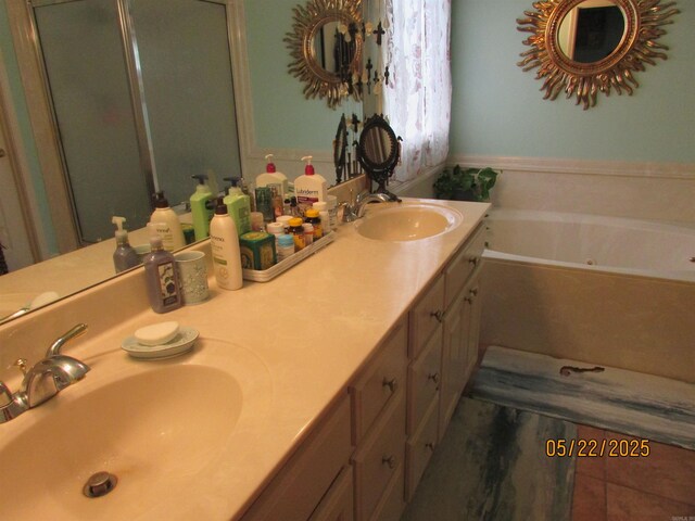 145 Eagles Nest Cv, Austin, AR 72007 - bathroom featuring a tub with jets, double vanity, tile patterned flooring, and a shower stall