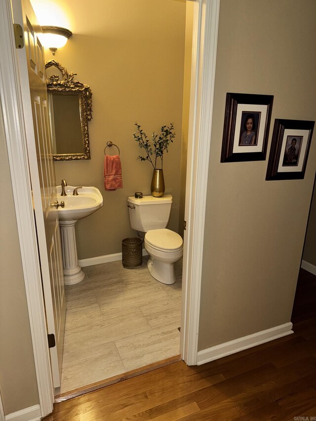 304 Quail Creek Rd, Hot Springs National Park, AR 71901 - half bathroom with toilet, baseboards, and wood finished floors