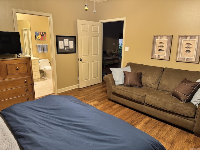 304 Quail Creek Rd, Hot Springs National Park, AR 71901 - bedroom featuring wood finished floors, ensuite bathroom, and baseboards