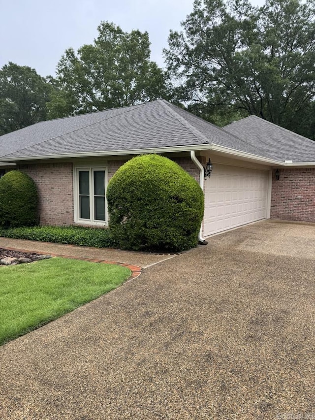 304 Quail Creek Rd, Hot Springs National Park, AR 71901 - view of property exterior with brick siding, a shingled roof, an attached garage, and concrete driveway