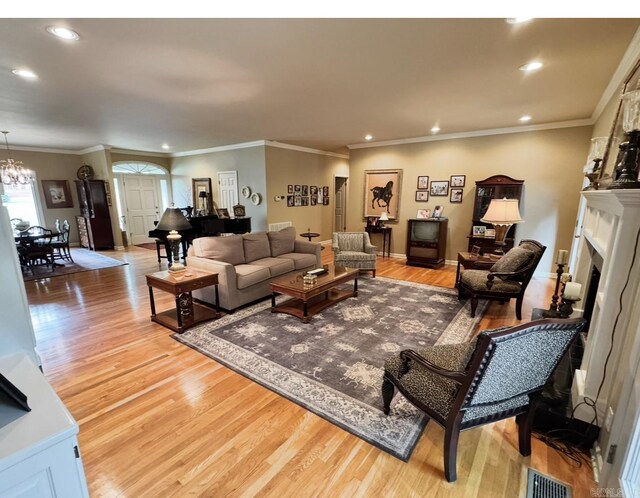 304 Quail Creek Rd, Hot Springs National Park, AR 71901 - living area with light wood-type flooring, recessed lighting, a chandelier, a fireplace, and ornamental molding
