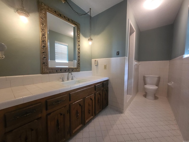 1008 W A Ave, North Little Rock, AR 72116 - bathroom with vanity, a wainscoted wall, and tile walls
