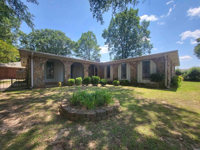1008 W A Ave, North Little Rock, AR 72116 - single story home featuring stone siding, a front yard, and board and batten siding