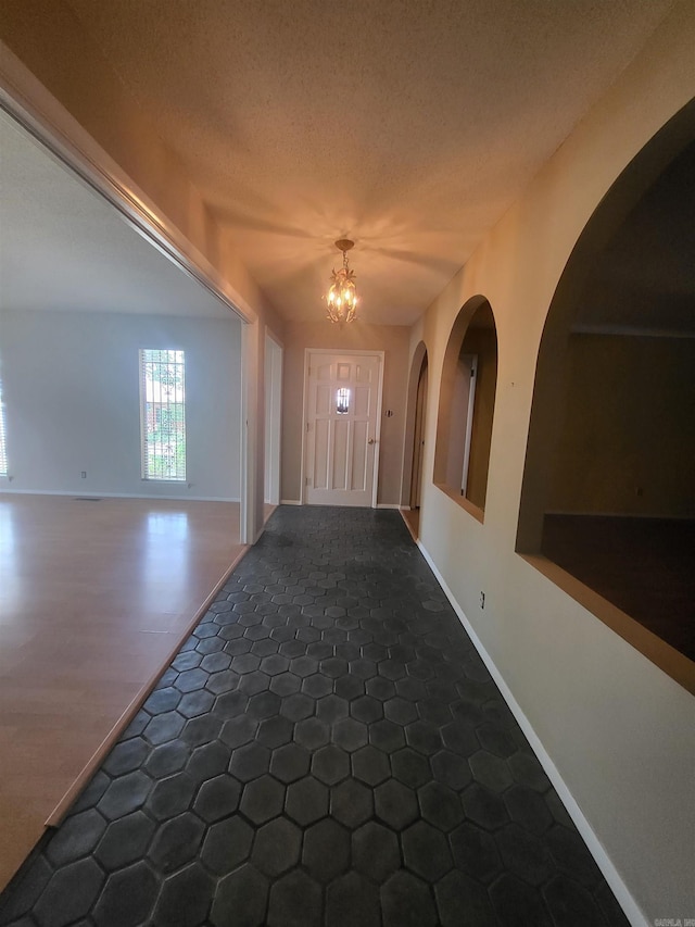 1008 W A Ave, North Little Rock, AR 72116 - entryway featuring a chandelier, arched walkways, and a textured ceiling