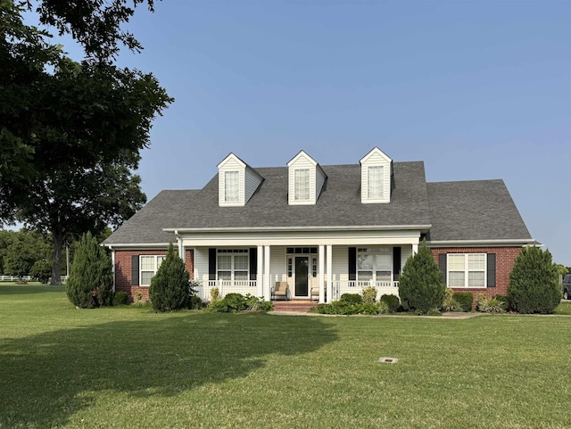 6484 N US Highway 61, Blytheville, AR 72315 - cape cod home with a front lawn, covered porch, and brick siding