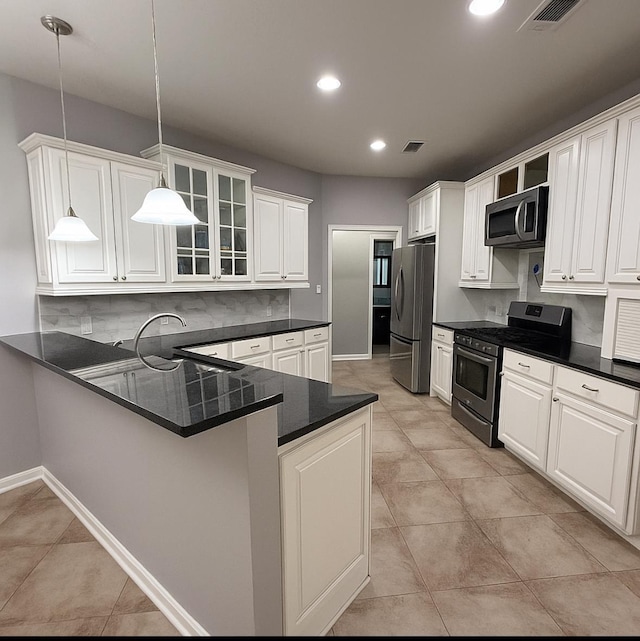 6484 N US Highway 61, Blytheville, AR 72315 - kitchen featuring stainless steel appliances, dark countertops, backsplash, glass insert cabinets, and pendant lighting