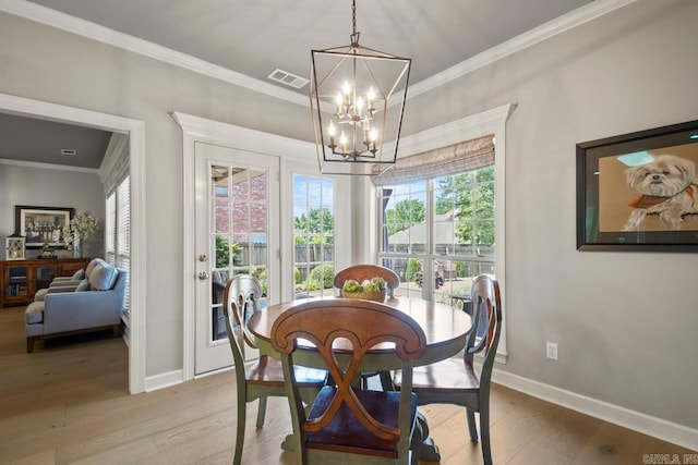 106 Hidden Falls Ln, Maumelle, AR 72113 - dining room with light wood-style flooring, a chandelier, and ornamental molding