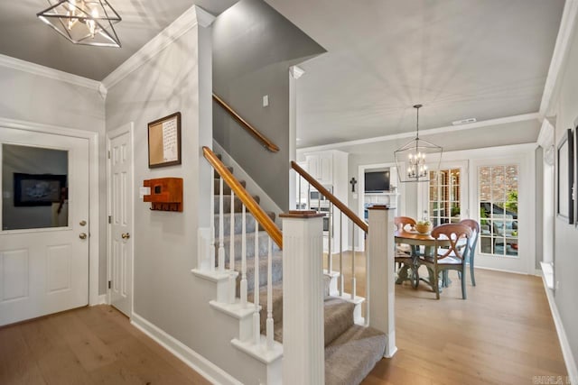106 Hidden Falls Ln, Maumelle, AR 72113 - stairway with a chandelier, wood finished floors, and crown molding