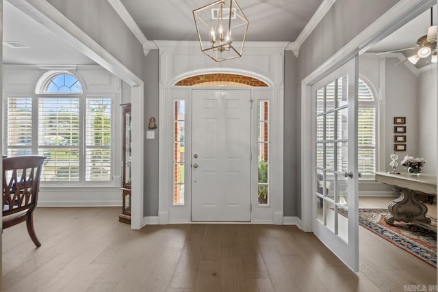 106 Hidden Falls Ln, Maumelle, AR 72113 - entrance foyer with light wood-style flooring, french doors, ornamental molding, a chandelier, and ceiling fan
