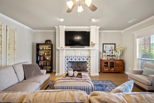 106 Hidden Falls Ln, Maumelle, AR 72113 - living room featuring ornamental molding, wood finished floors, ceiling fan, and a tile fireplace