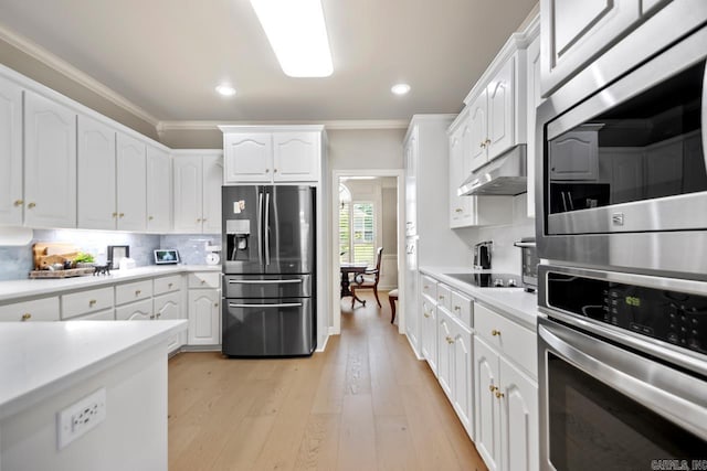 106 Hidden Falls Ln, Maumelle, AR 72113 - kitchen with stainless steel appliances, crown molding, white cabinetry, light countertops, and recessed lighting