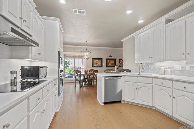 106 Hidden Falls Ln, Maumelle, AR 72113 - kitchen with appliances with stainless steel finishes, crown molding, white cabinets, recessed lighting, and a chandelier
