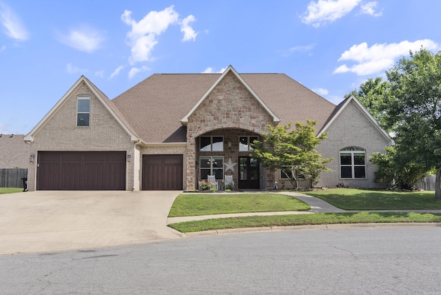 5526 Palisades Cv, Benton, AR 72019 - view of front of home with a front yard, concrete driveway, a garage, and brick siding