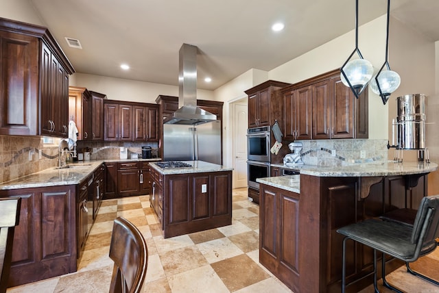 5526 Palisades Cv, Benton, AR 72019 - kitchen featuring island range hood, stainless steel appliances, a peninsula, tasteful backsplash, and recessed lighting