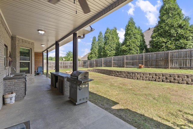 5526 Palisades Cv, Benton, AR 72019 - fenced backyard with grilling area, a patio, and a ceiling fan