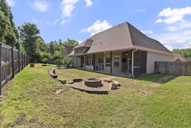 5526 Palisades Cv, Benton, AR 72019 - back of house with a fire pit, a fenced backyard, brick siding, a patio, and a shingled roof