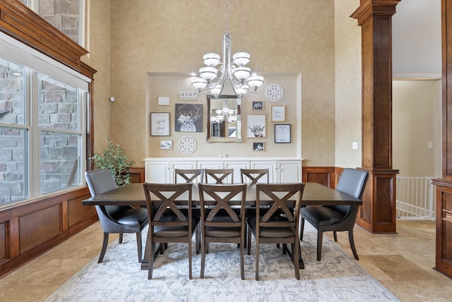 5526 Palisades Cv, Benton, AR 72019 - dining space featuring a high ceiling, a chandelier, and decorative columns