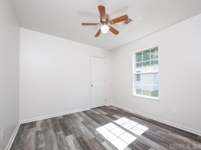 1121 Stewart St, Benton, AR 72015 - unfurnished room featuring wood finished floors and a ceiling fan