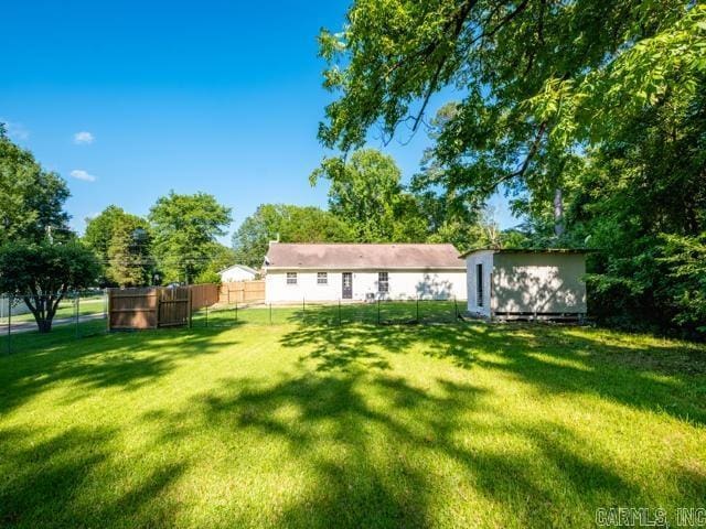 1121 Stewart St, Benton, AR 72015 - rear view of property featuring a storage shed