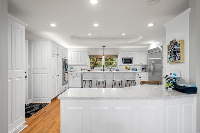 308 Bellaire, Hot Springs, AR 71901 - kitchen featuring stainless steel appliances, light wood-type flooring, decorative backsplash, white cabinetry, and recessed lighting