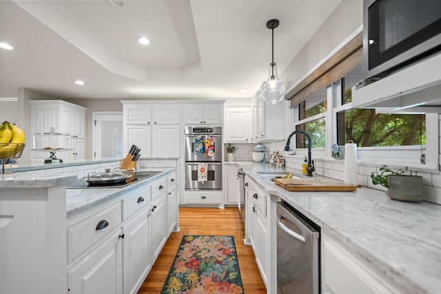308 Bellaire, Hot Springs, AR 71901 - kitchen with stainless steel appliances, white cabinetry, backsplash, light wood-type flooring, and recessed lighting