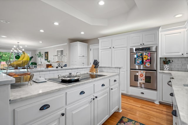 308 Bellaire, Hot Springs, AR 71901 - kitchen featuring stainless steel double oven, electric stovetop, tasteful backsplash, white cabinetry, and recessed lighting