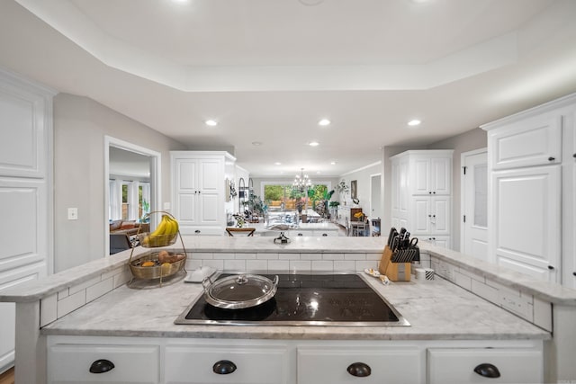 308 Bellaire, Hot Springs, AR 71901 - kitchen with black electric stovetop, white cabinetry, recessed lighting, a chandelier, and a center island