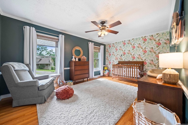 308 Bellaire, Hot Springs, AR 71901 - bedroom featuring crown molding, multiple windows, light wood-style flooring, a crib, and wallpapered walls