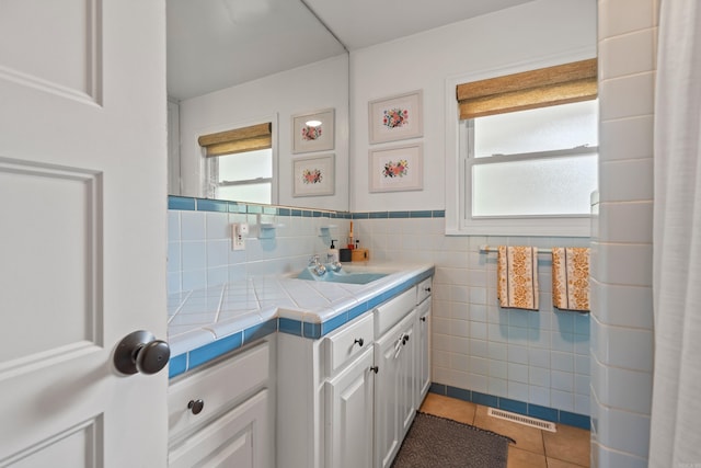 308 Bellaire, Hot Springs, AR 71901 - bathroom featuring tile patterned flooring, healthy amount of natural light, vanity, and tile walls