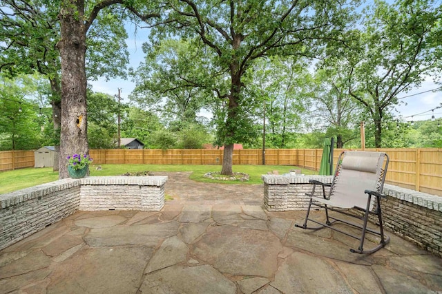 308 Bellaire, Hot Springs, AR 71901 - fenced backyard featuring a patio, a storage unit, and view of wooded area