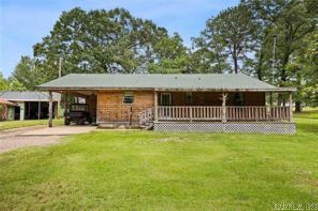 1440 N Shore Rd, Atkins, AR 72823 - back of house featuring concrete driveway, a yard, and a porch