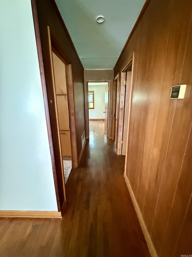 811 Hester St, Jonesboro, AR 72401 - hallway featuring dark wood finished floors and wood walls