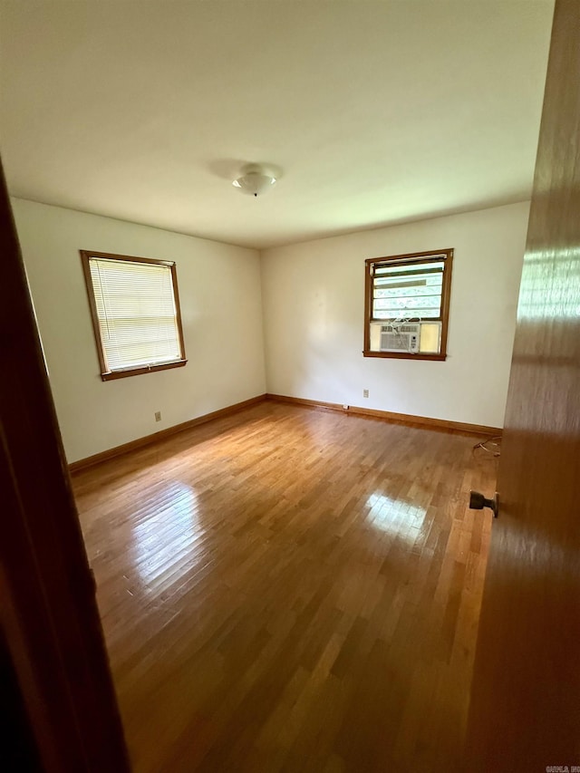 811 Hester St, Jonesboro, AR 72401 - empty room with wood finished floors and cooling unit