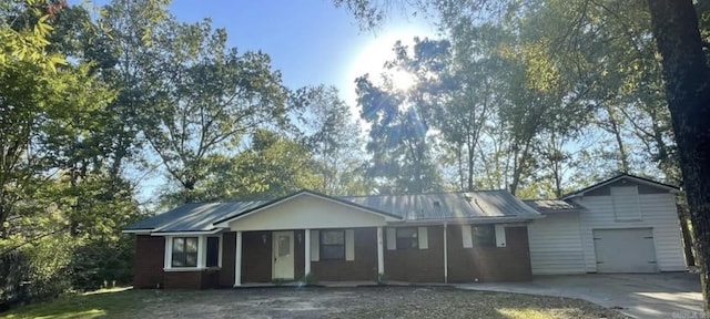 2 Concord Dr, Conway, AR 72034 - ranch-style house with driveway, an attached garage, and a metal roof