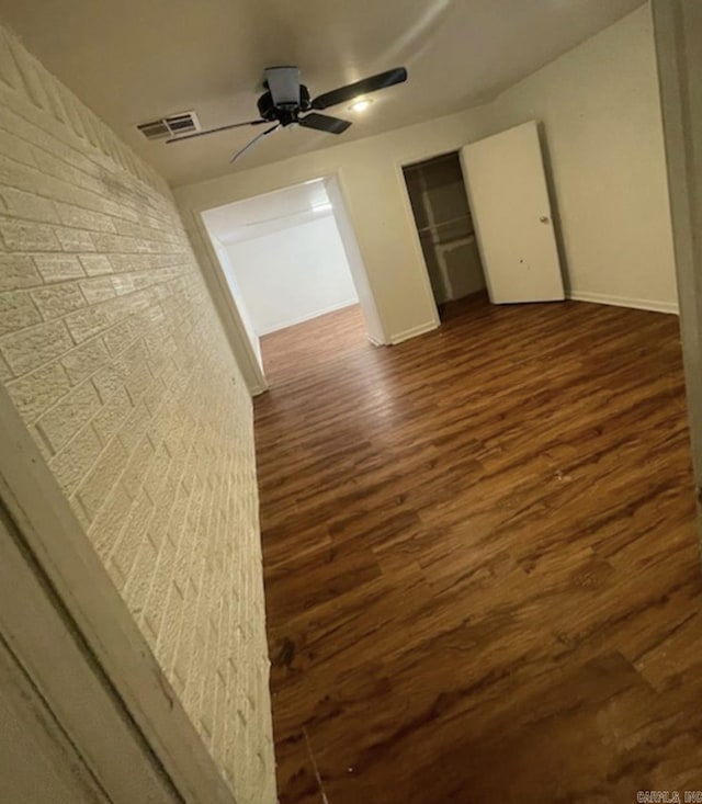 2 Concord Dr, Conway, AR 72034 - unfurnished bedroom featuring dark wood-type flooring, a ceiling fan, and a closet